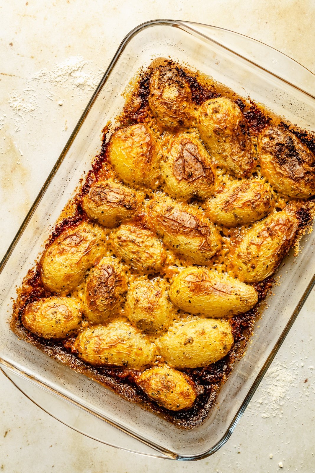 parmesan roasted potatoes in a glass pan