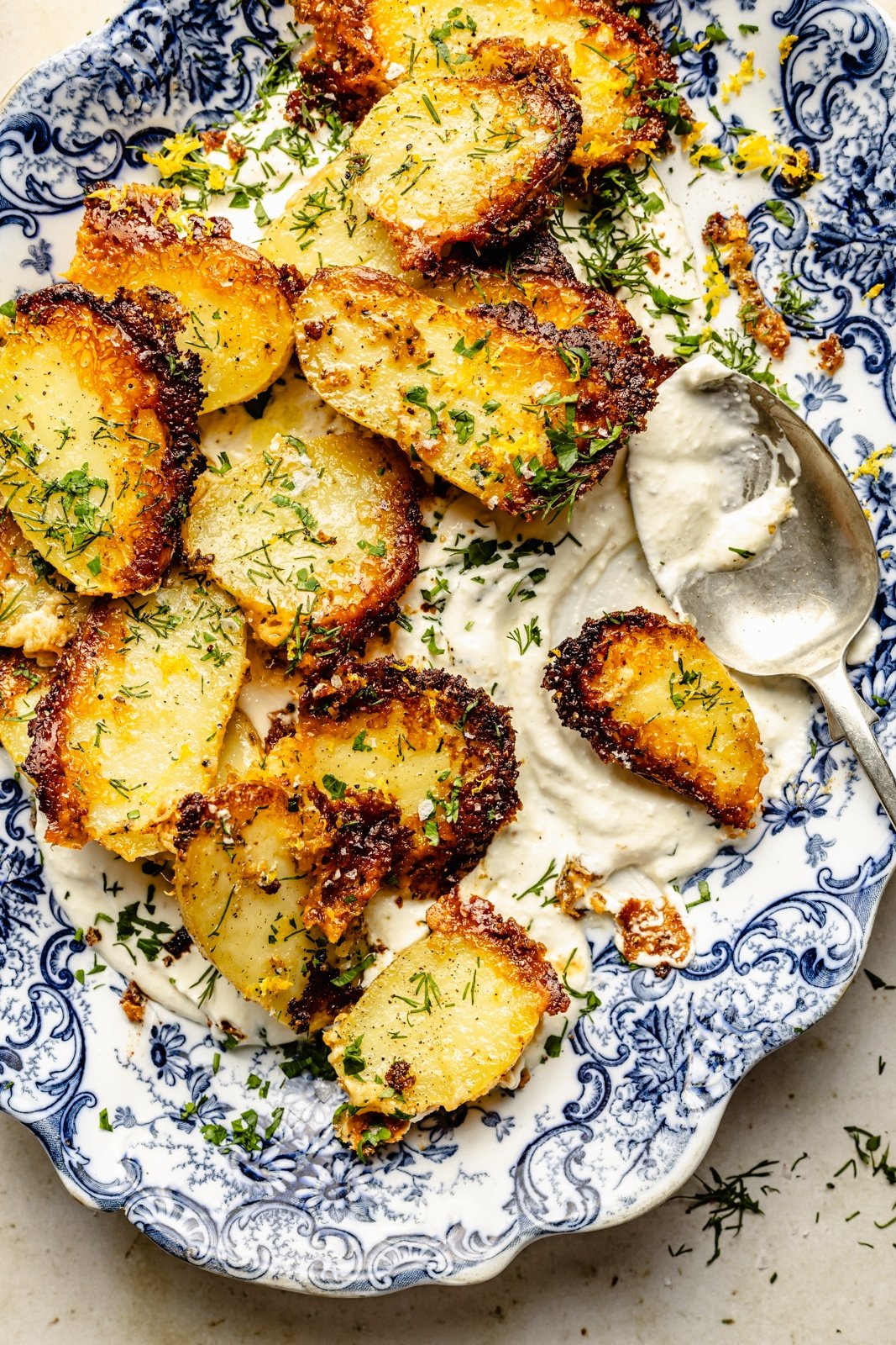 roasted parmesan potatoes in a bowl with garlic feta dip