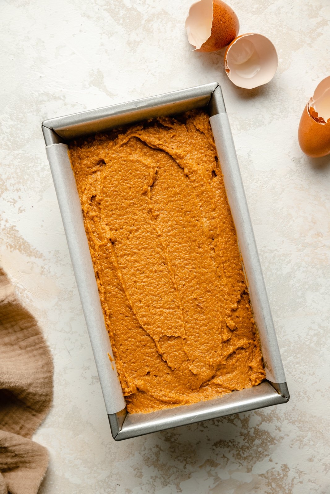 unbaked pumpkin bread in a loaf pan