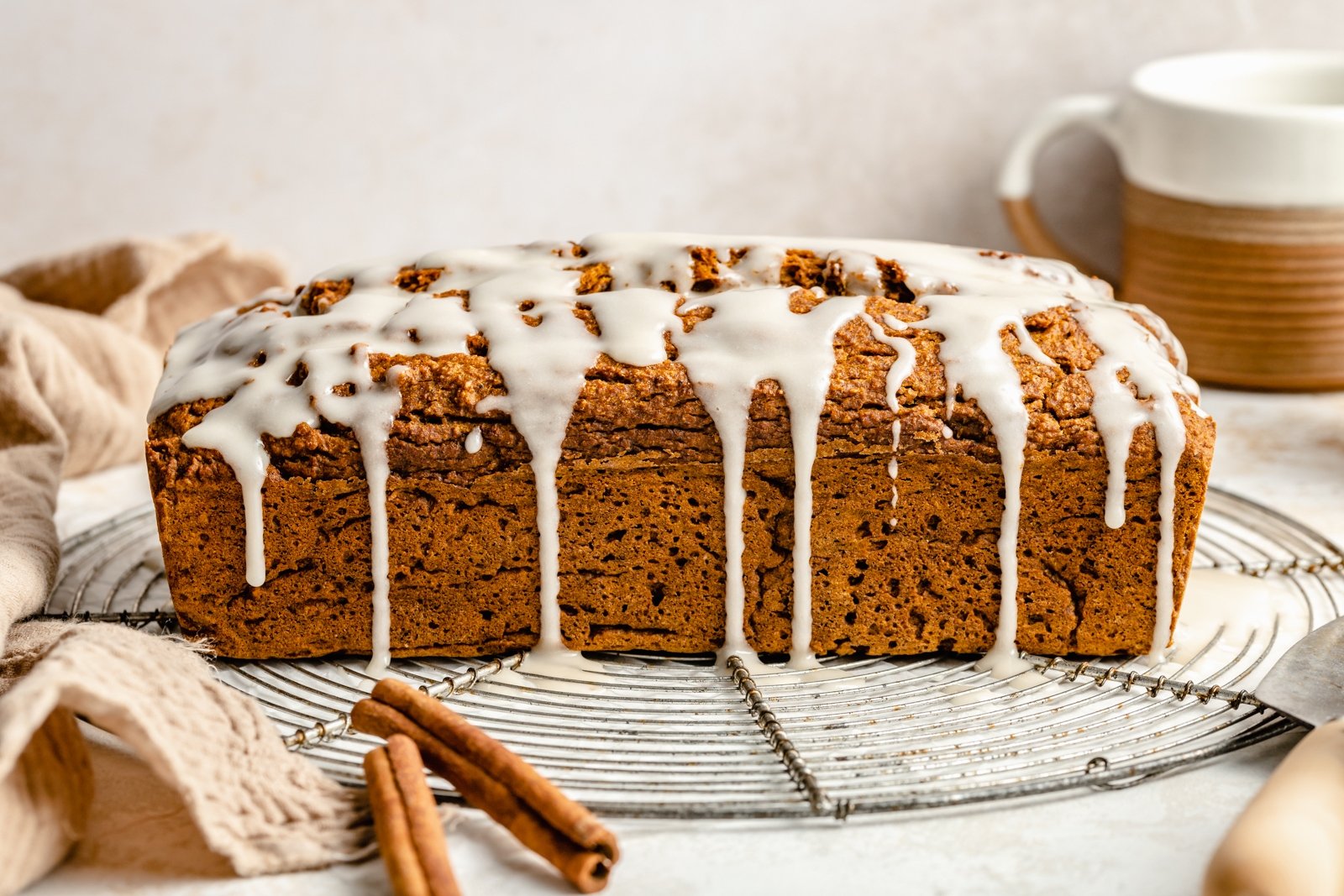 healthy pumpkin loaf with glaze on a wire rack