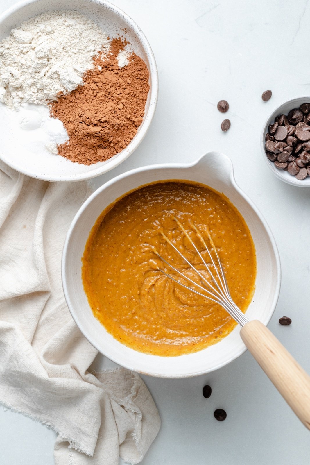 mixing wet ingredients for almond butter chocolate pumpkin muffins