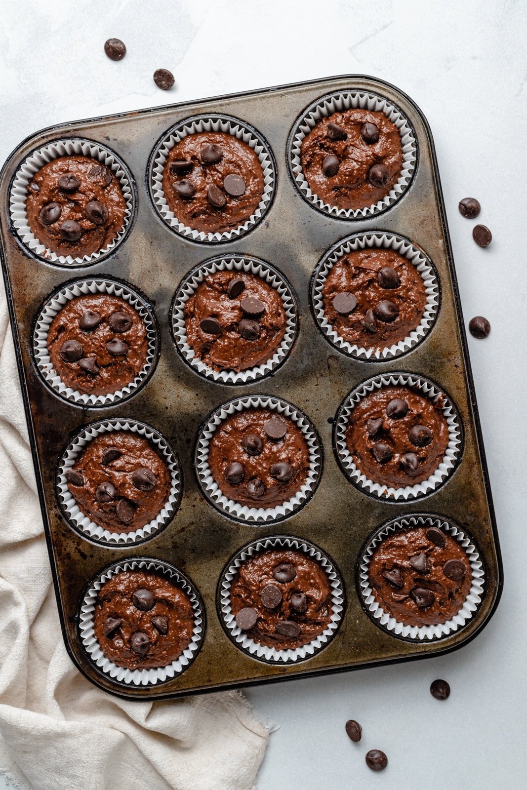 unbaked almond butter chocolate pumpkin muffins in a muffin tin