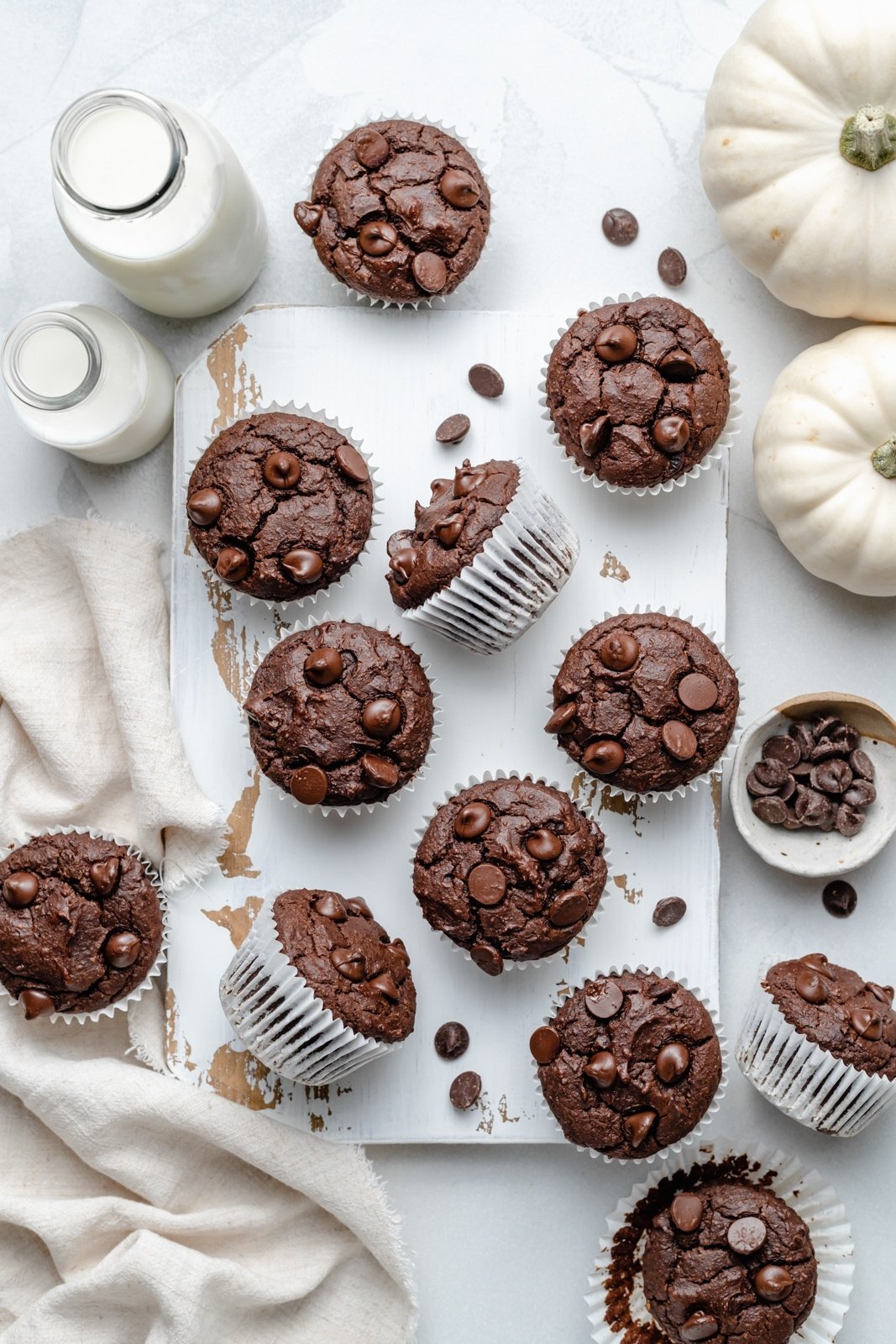 gluten free chocolate almond butter pumpkin muffins on a board