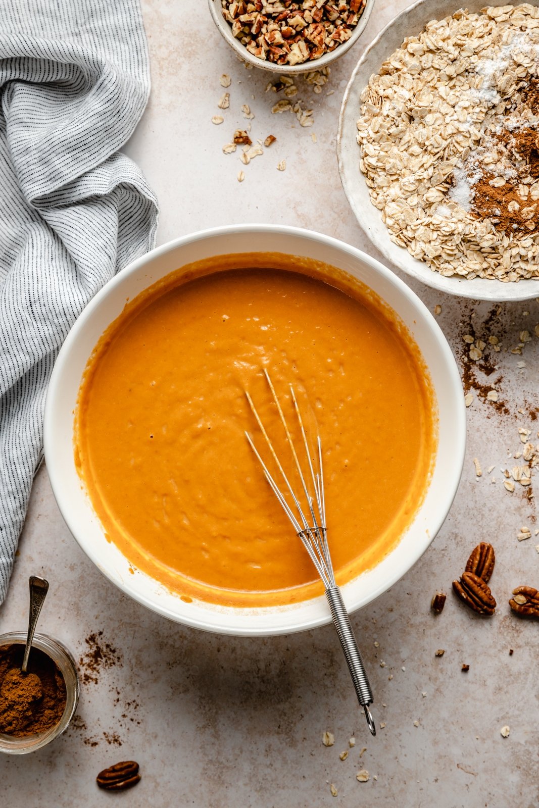 mixing ingredients to make a pumpkin baked oatmeal