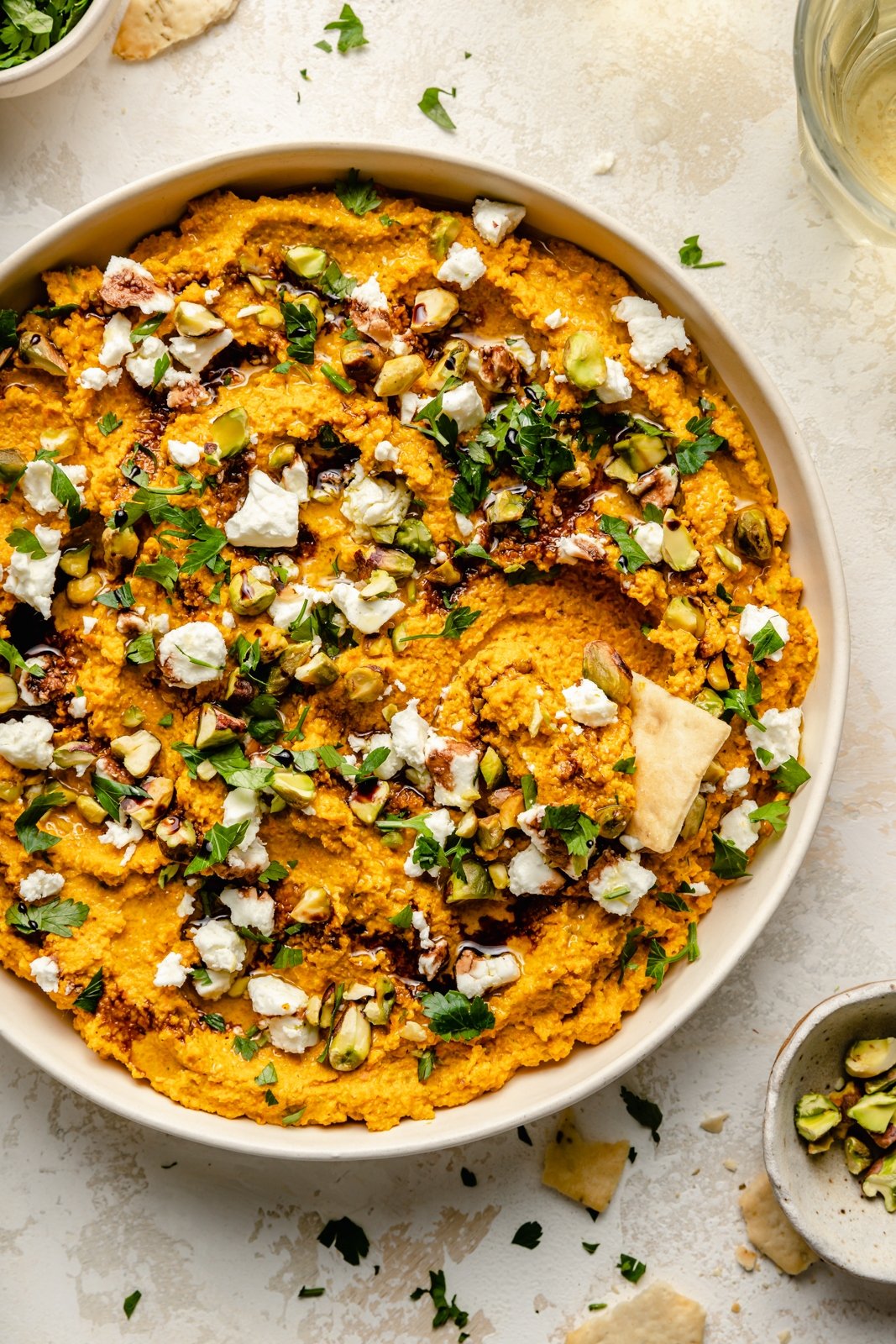 healthy carrot dip in a bowl with herbs and feta