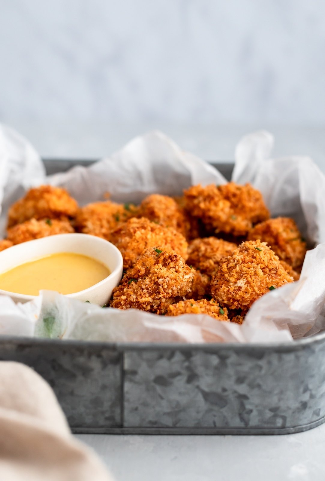 baked chicken nuggets in a tray with honey mustard dip