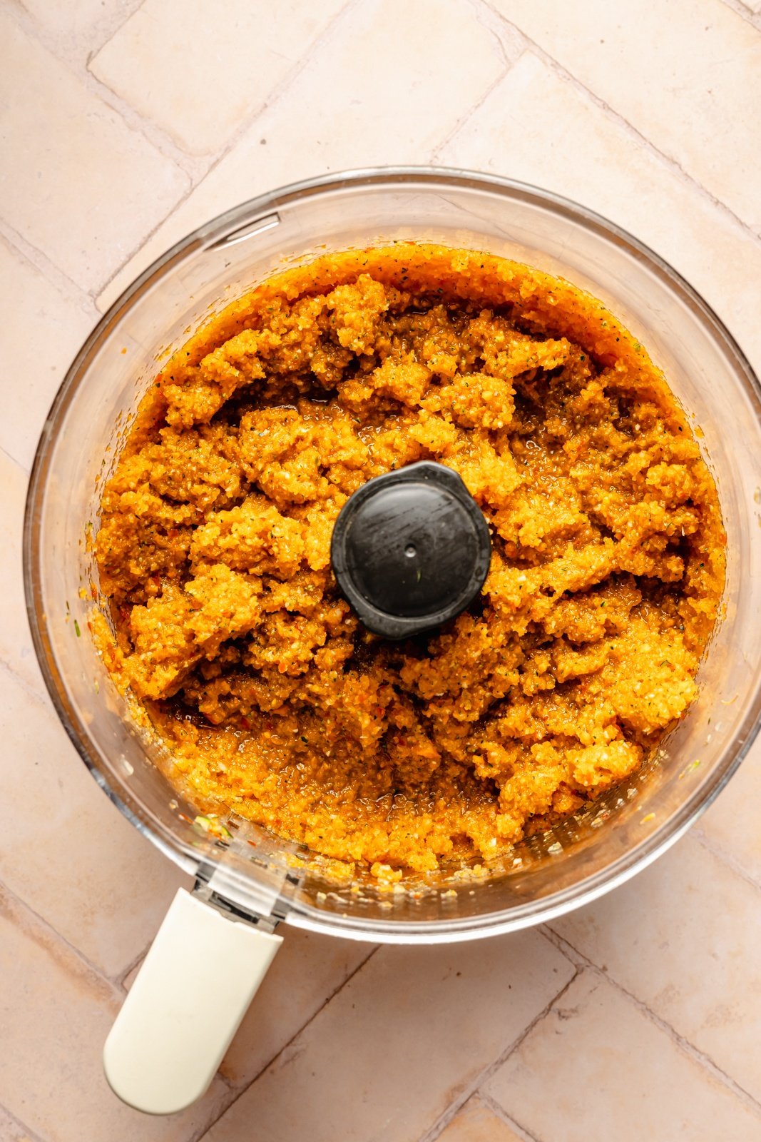 blending vegetables in a food processor to make a healthy meat sauce