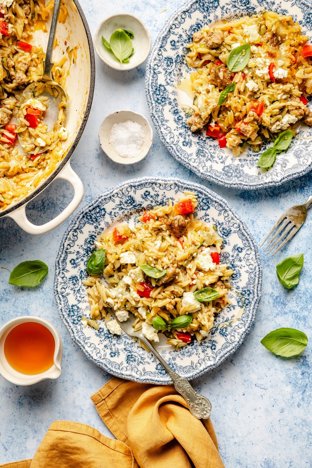 zucchini sausage baked orzo served on plates