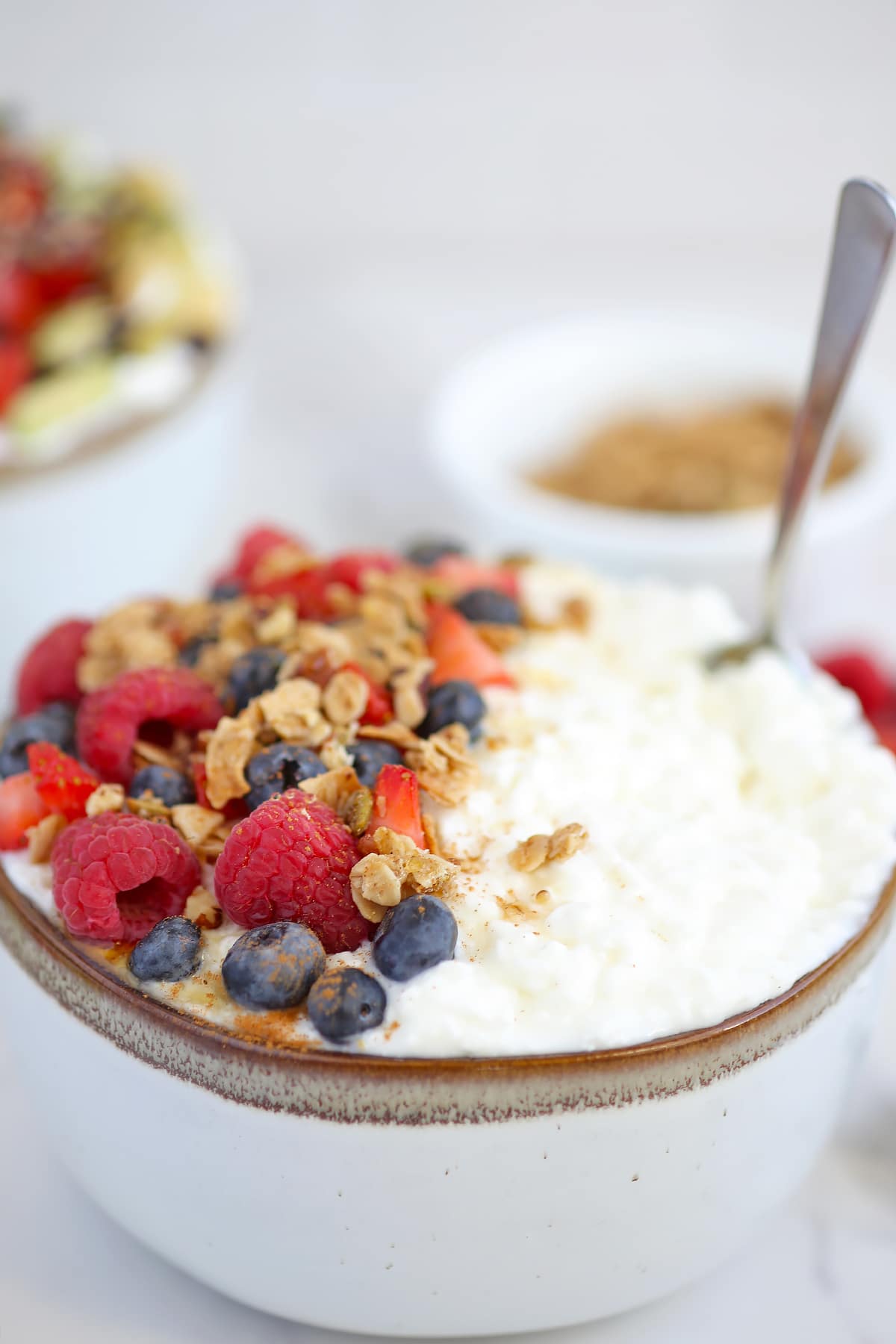 a bowl of cottage cheese with berries and granola