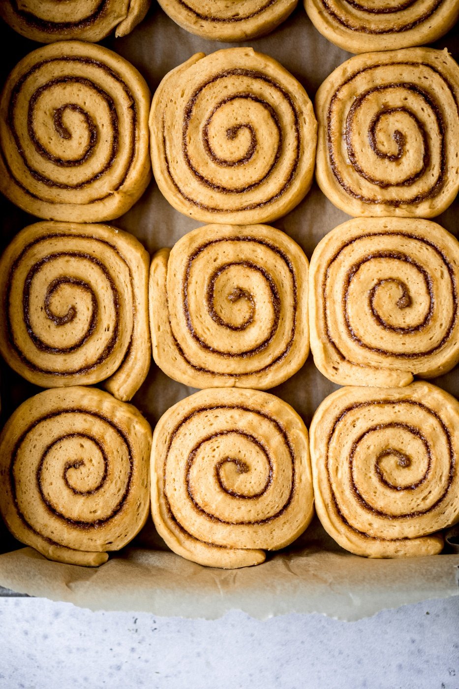 pumpkin cinnamon rolls in a pan before being baked