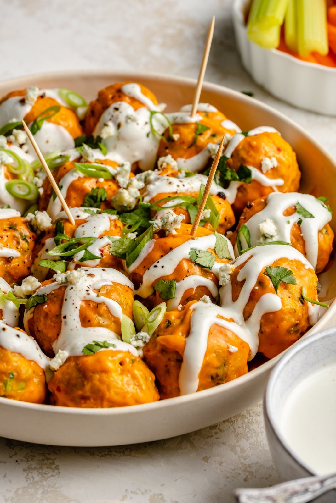 Over 20 of the best Thanksgiving appetizers that are guaranteed to impress family and friends! You'll find unique crostini recipes, savory handhelds, delicious dips, and more for your Thanksgiving menu or to bring as a guest this holiday season. These easy Thanksgiving apps might just outshine the turkey! healthy buffalo chicken meatballs drizzled with bleu cheese dressing