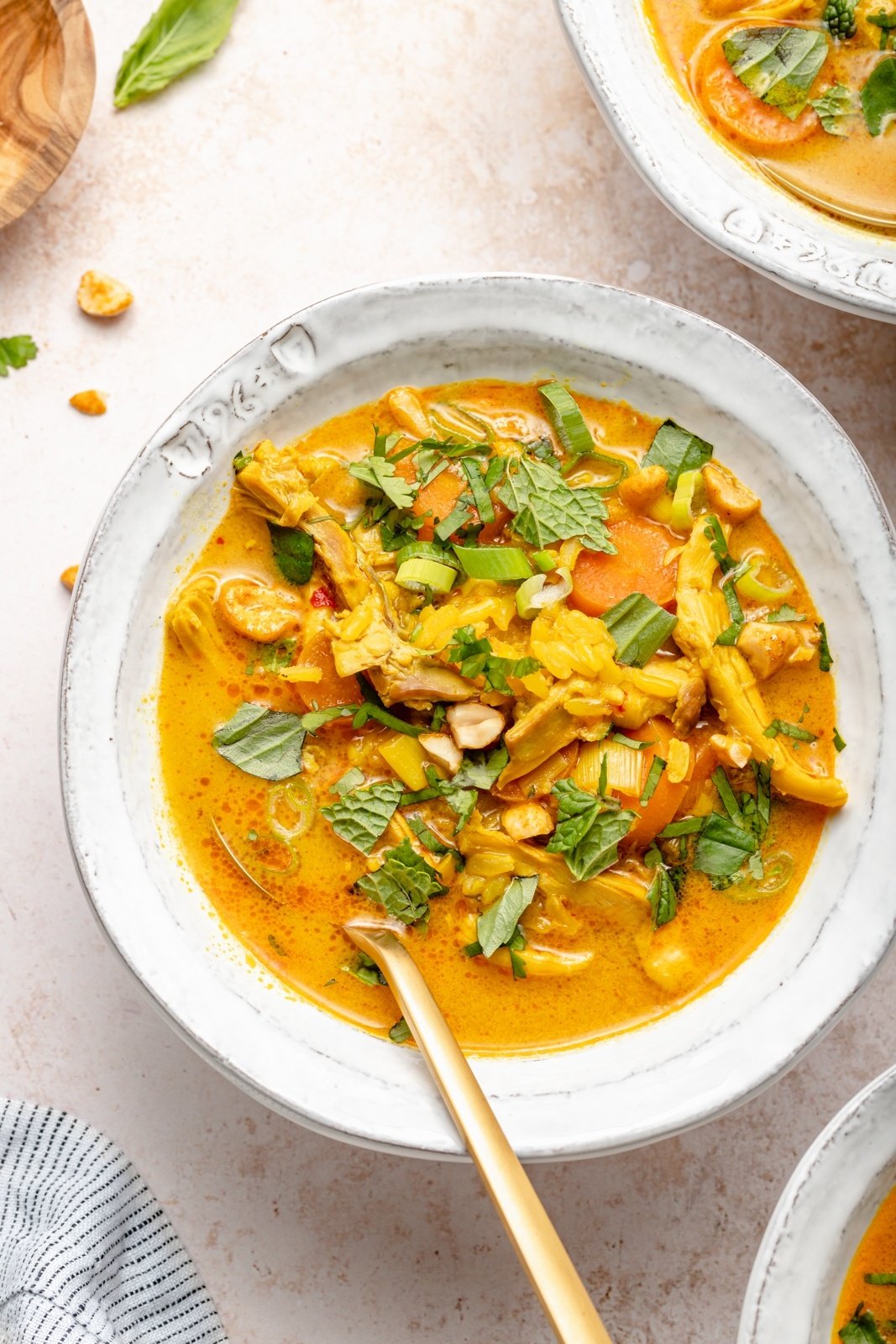 ginger chicken soup in a bowl with herbs