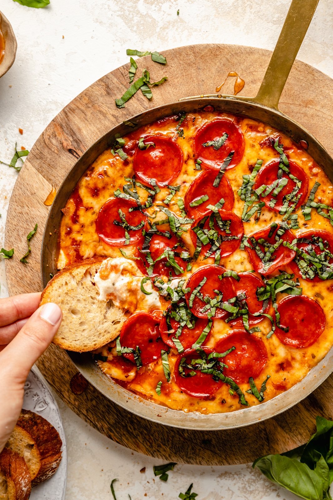 dipping a crostini in pizza dip