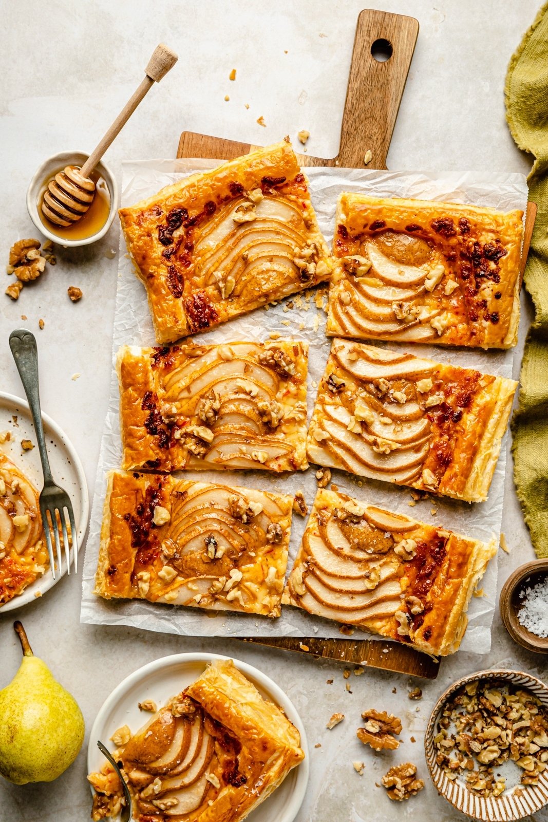 pear puff pastry tart sliced on parchment paper