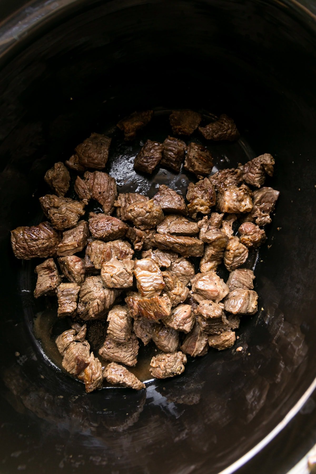 Brown the beef and add to slow cooker.