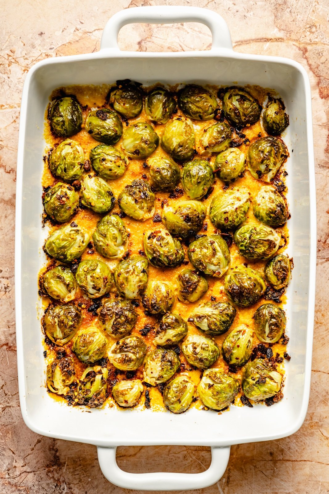 spicy parmesan brussels sprouts in a baking dish