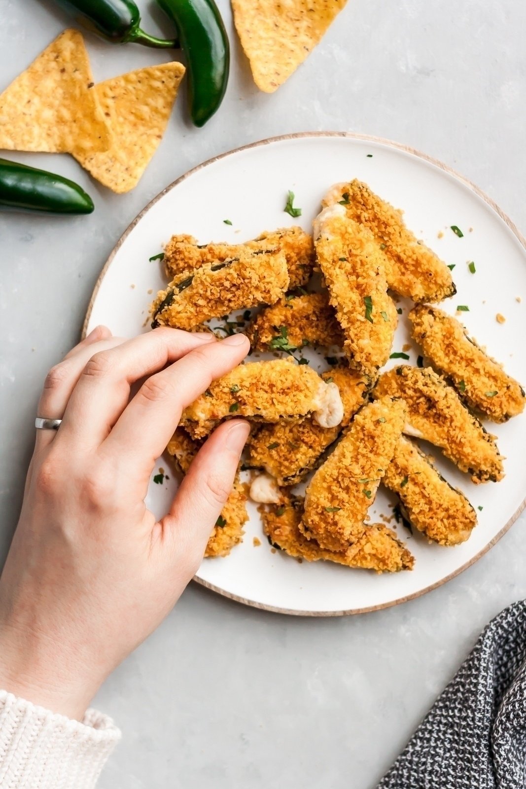 Over 20 of the best Thanksgiving appetizers that are guaranteed to impress family and friends! You'll find unique crostini recipes, savory handhelds, delicious dips, and more for your Thanksgiving menu or to bring as a guest this holiday season. These easy Thanksgiving apps might just outshine the turkey! healthy baked jalapeno poppers on a plate