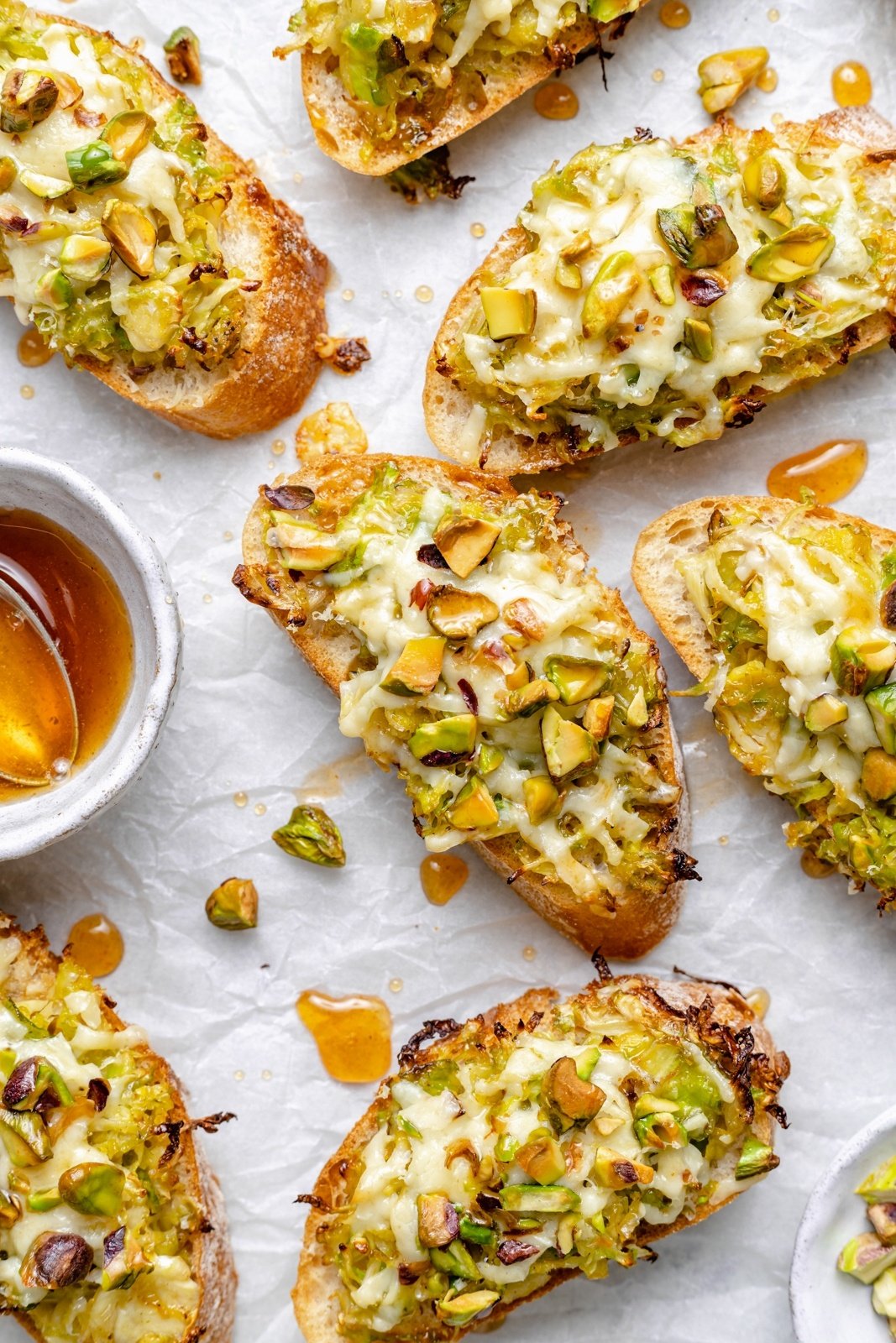 white cheddar brussels sprouts crostini on parchment paper
