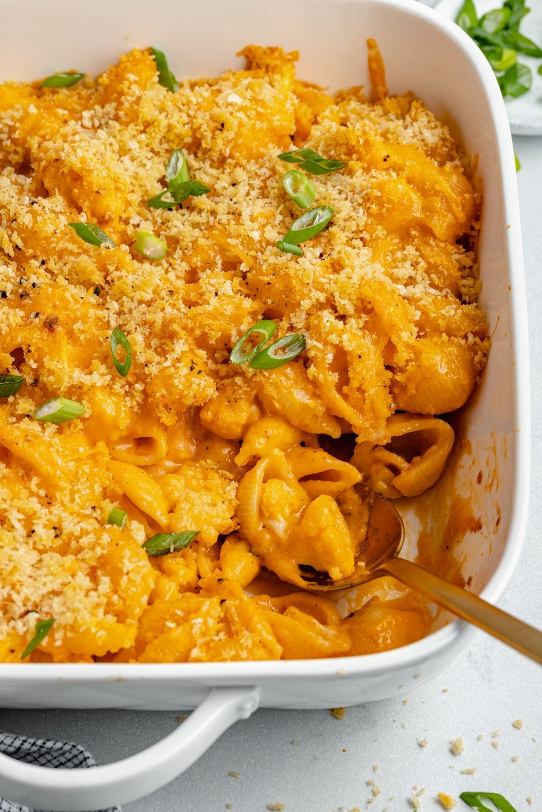 buffalo cauliflower mac and cheese in a baking dish with a spoon