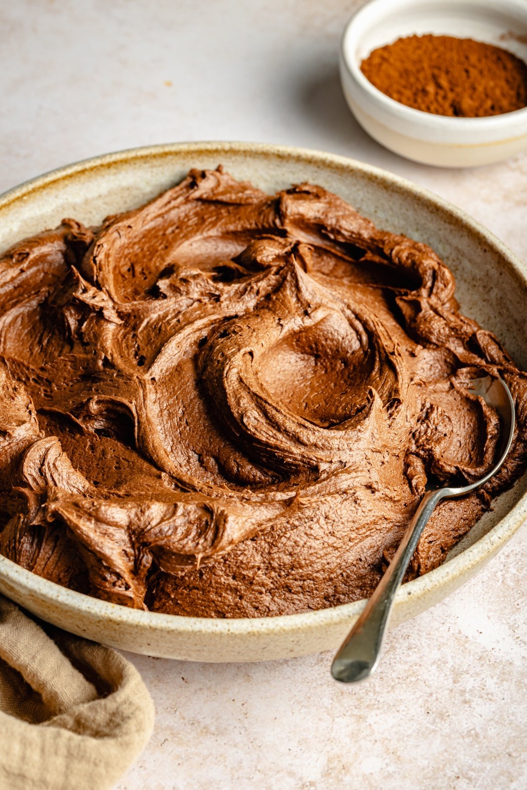 chocolate buttercream frosting in a bowl with a spoon