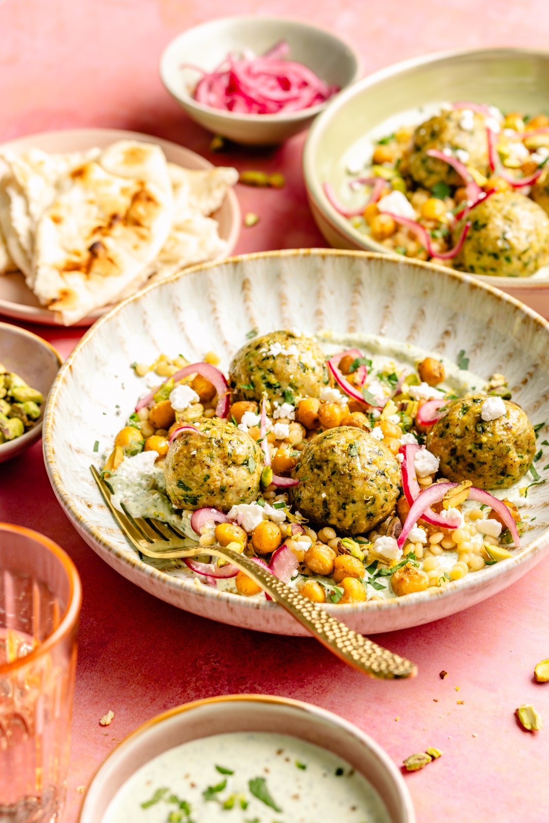 pistachio chicken meatballs with chickpeas and couscous in a bowl