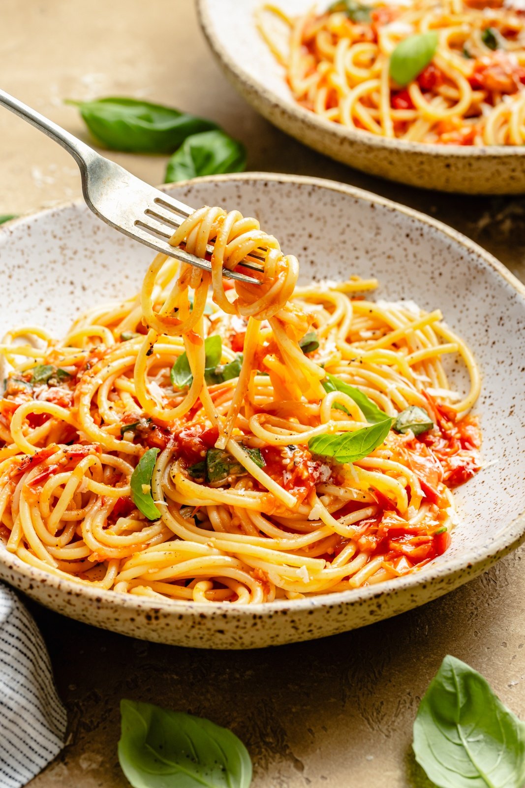 pulling pasta pomodoro out of a bowl with a fork
