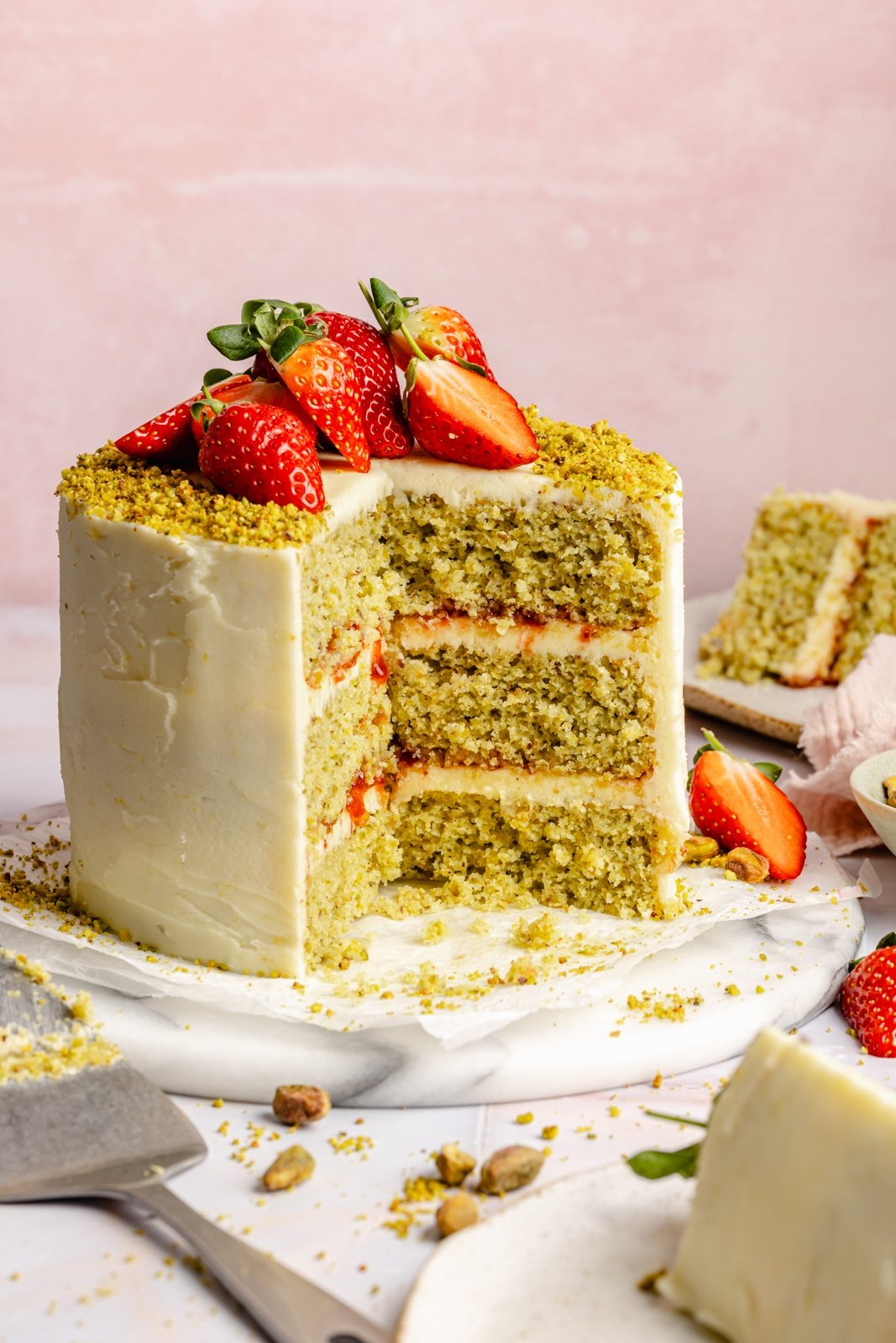 lemon pistachio cake with a slice cut out