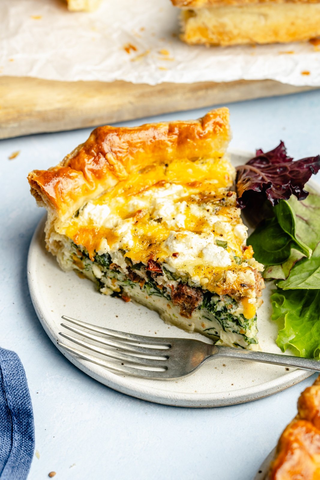slice of spinach puff pastry quiche on a plate