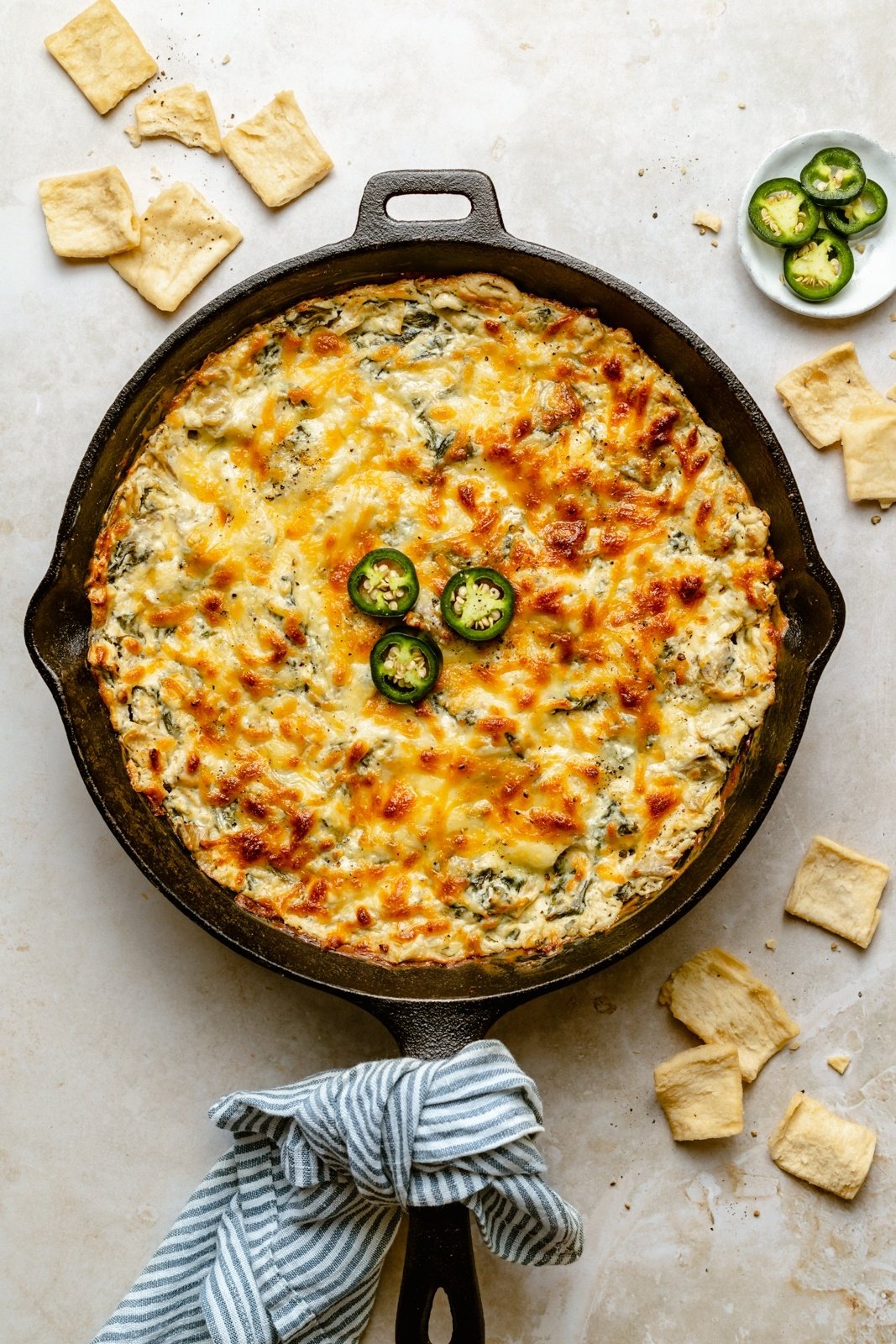 easy spinach artichoke dip with jalapeños in a skillet