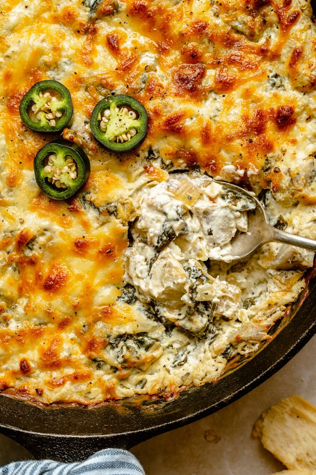 spicy spinach artichoke dip with jalapeño in a skillet