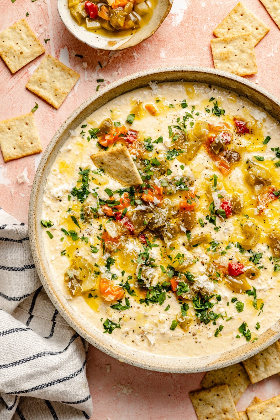 cottage cheese giardiniera dip in a serving bowl next to crackers
