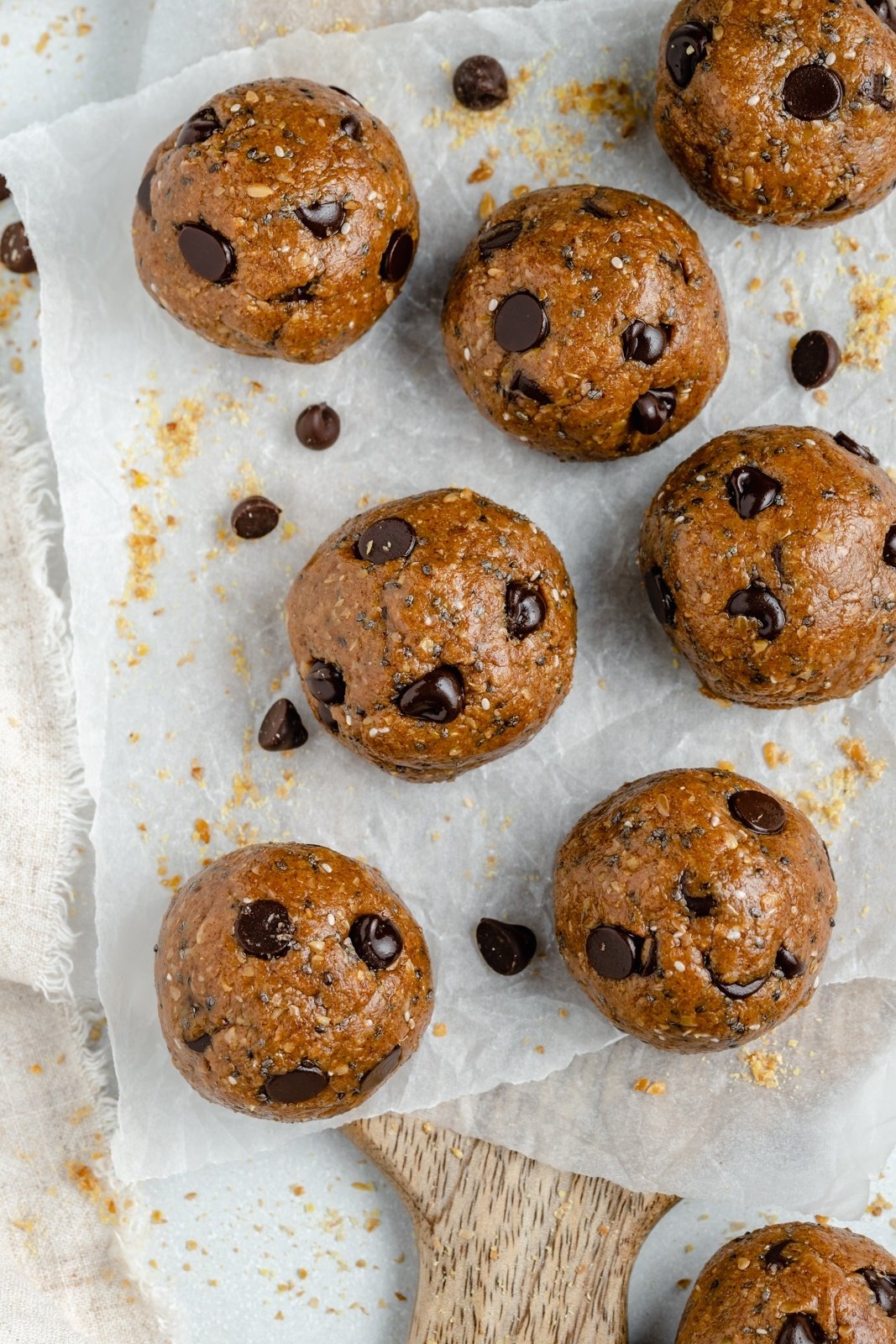no bake almond butter energy bites with chocolate chips on parchment paper