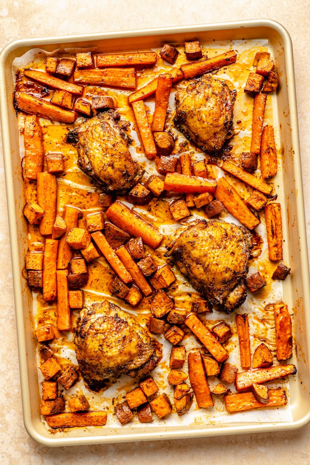 sheet pan hot honey chicken and veggies on a baking sheet