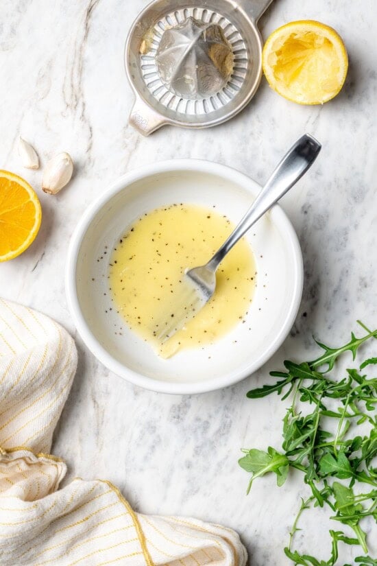 Pan seared scallops taste like a special occasion dinner but they’re easy enough for a weeknight. Serve over salad for a light, healthy meal! Overhead view of mojo vinaigrette in bowl with fork