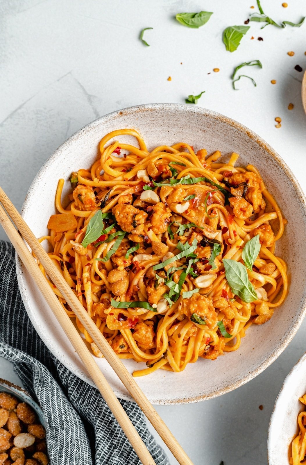 hot chili chicken noodles in a bowl with chopsticks