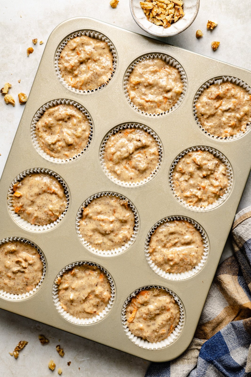 unbaked apple banana carrot muffins in a muffin tin