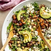 chickpea arugula quinoa salad with avocado in a bowl