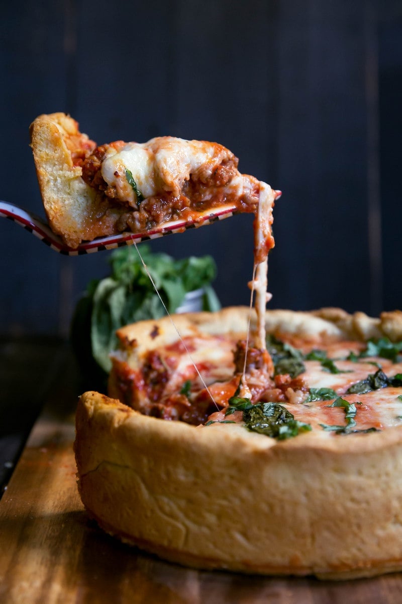 serving slice of homemade deep dish pizza