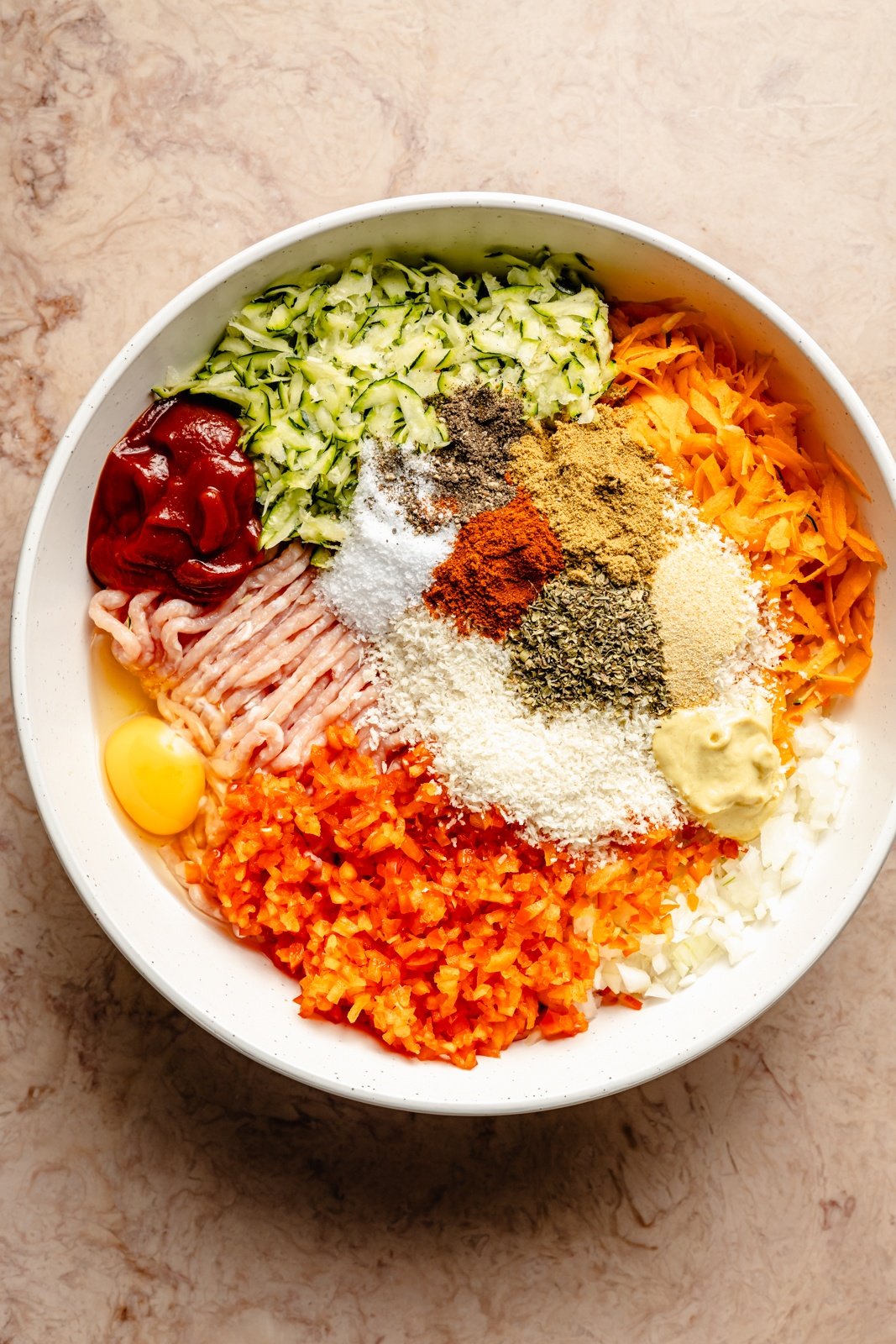 ingredients for a veggie-packed chicken meatloaf in a bowl