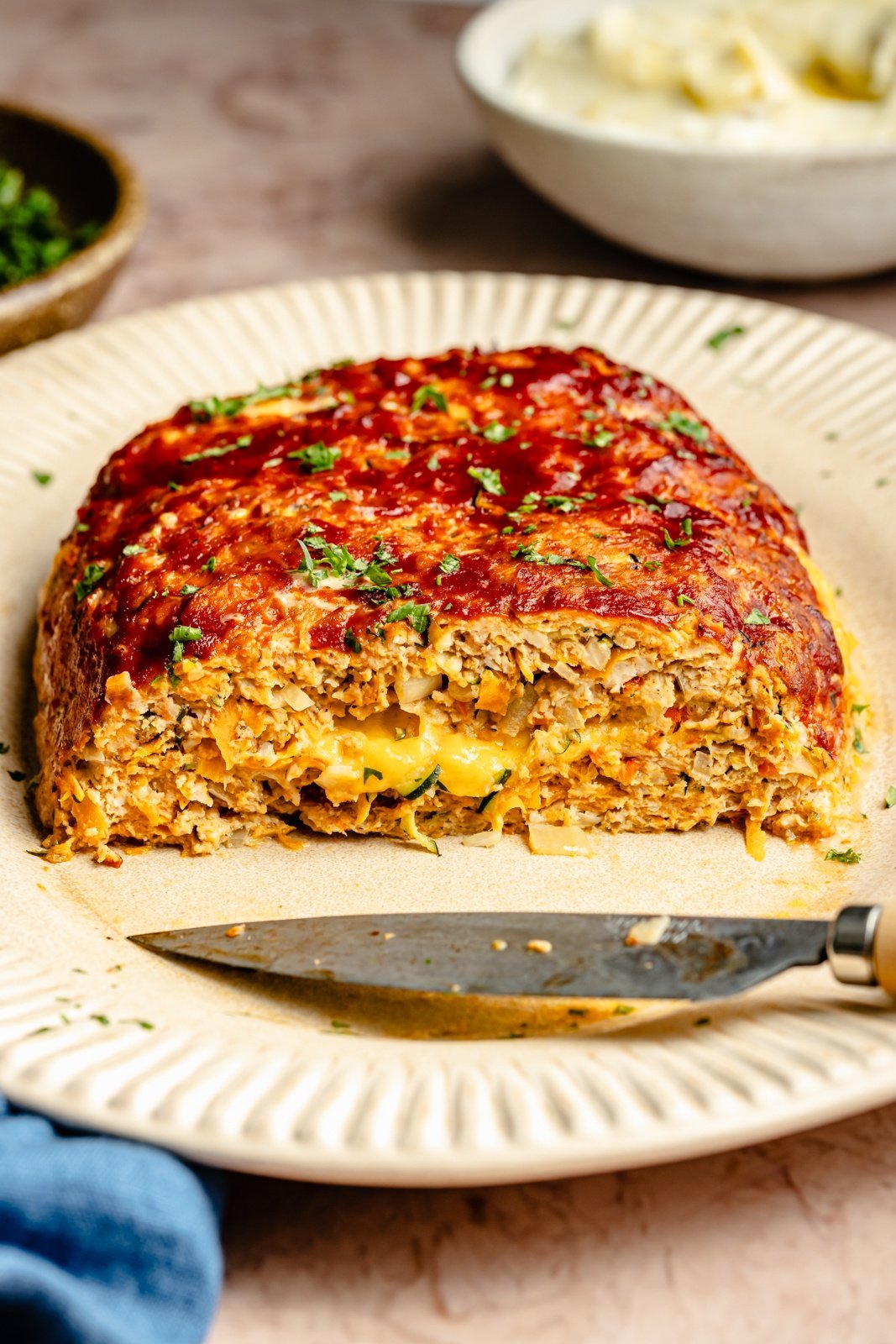 healthy chicken meatloaf stuffed with cheese on a plate