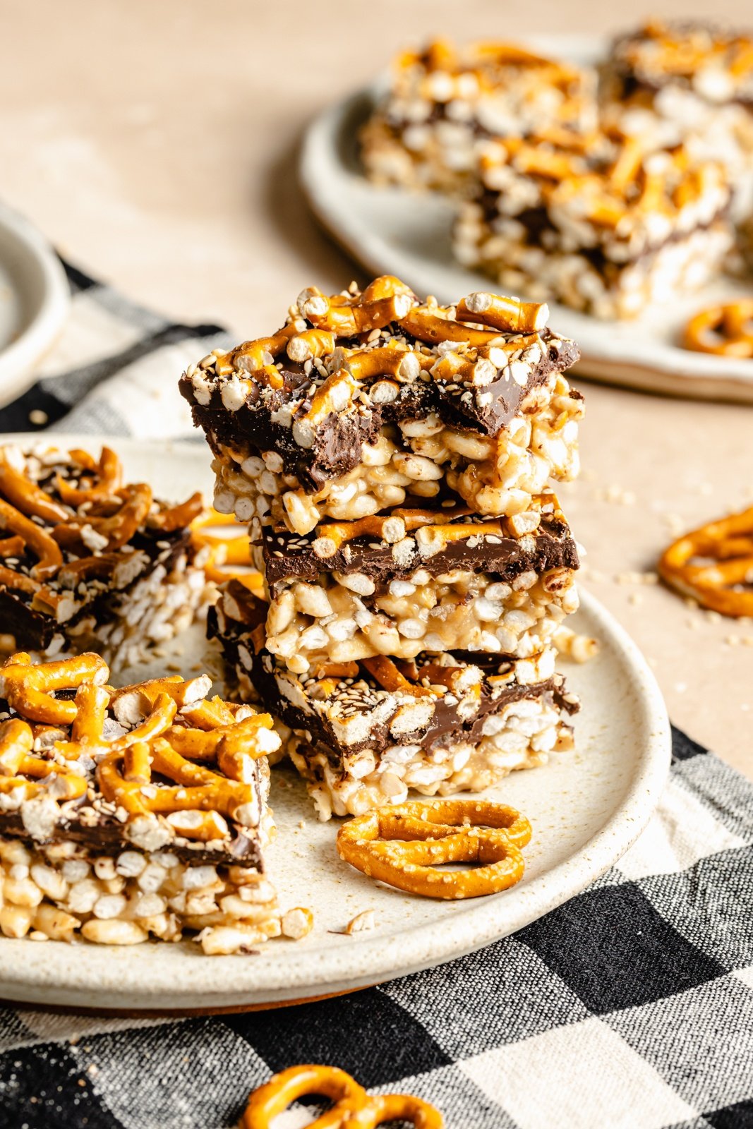 tahini rice krispie treats topped with pretzels in a stack
