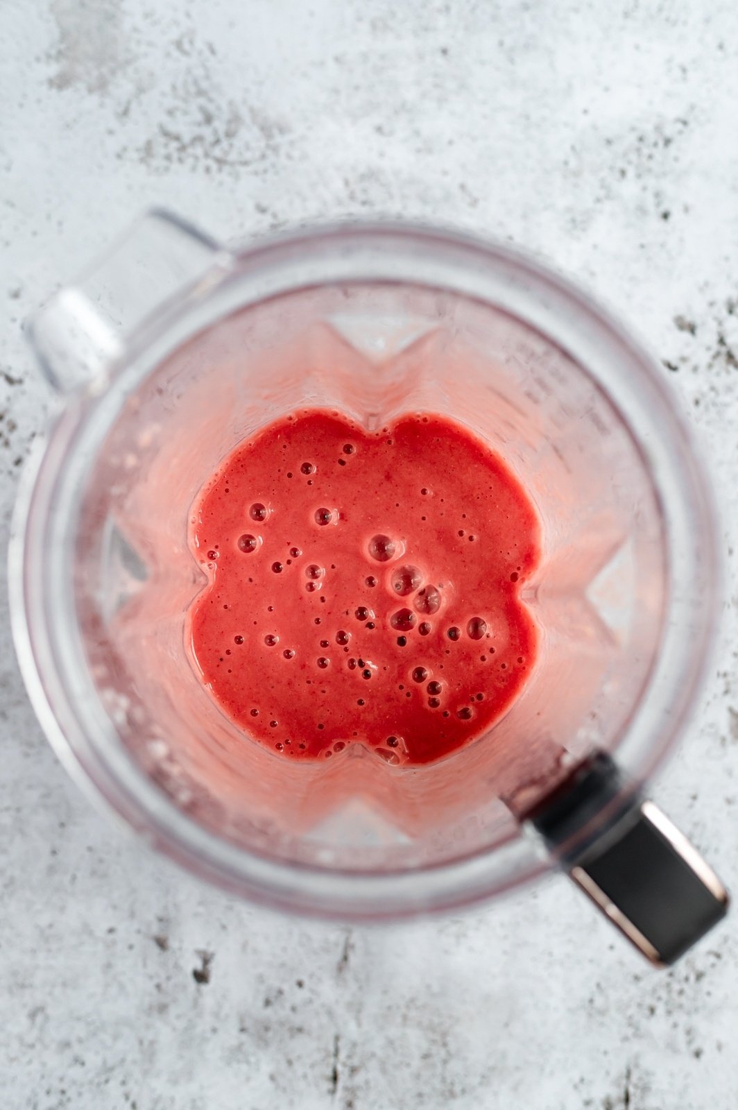 orange strawberry banana smoothie in a blender