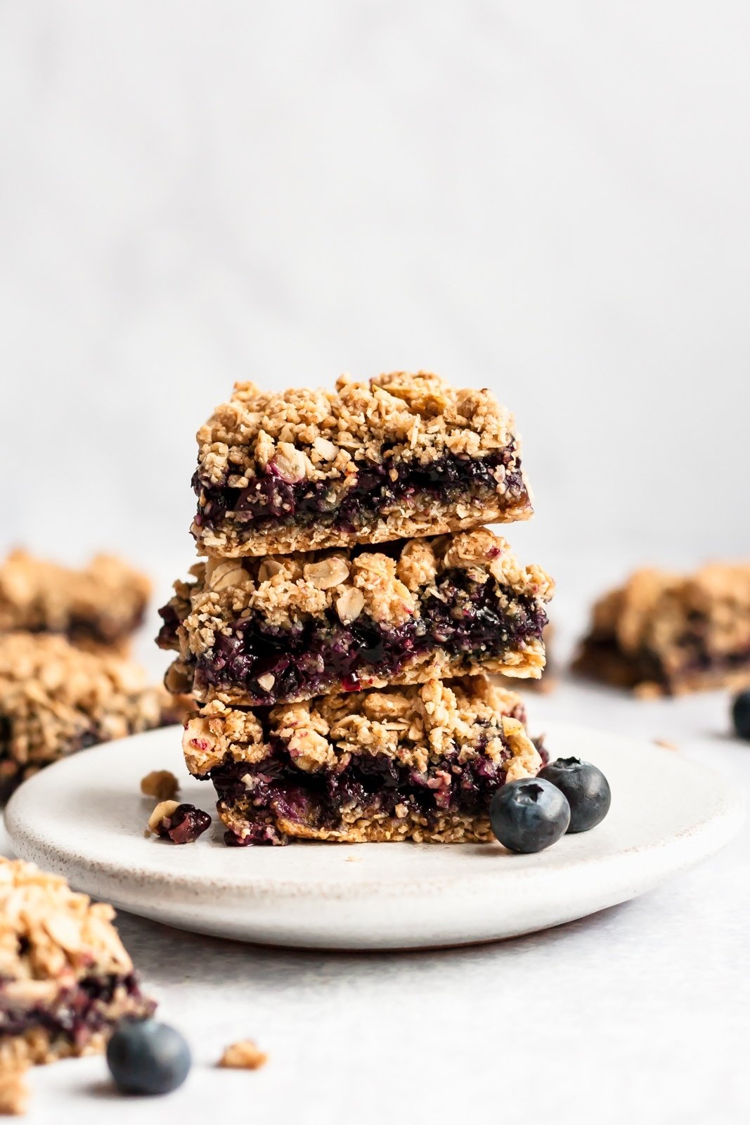 blueberry pie bars in a stack on a plate