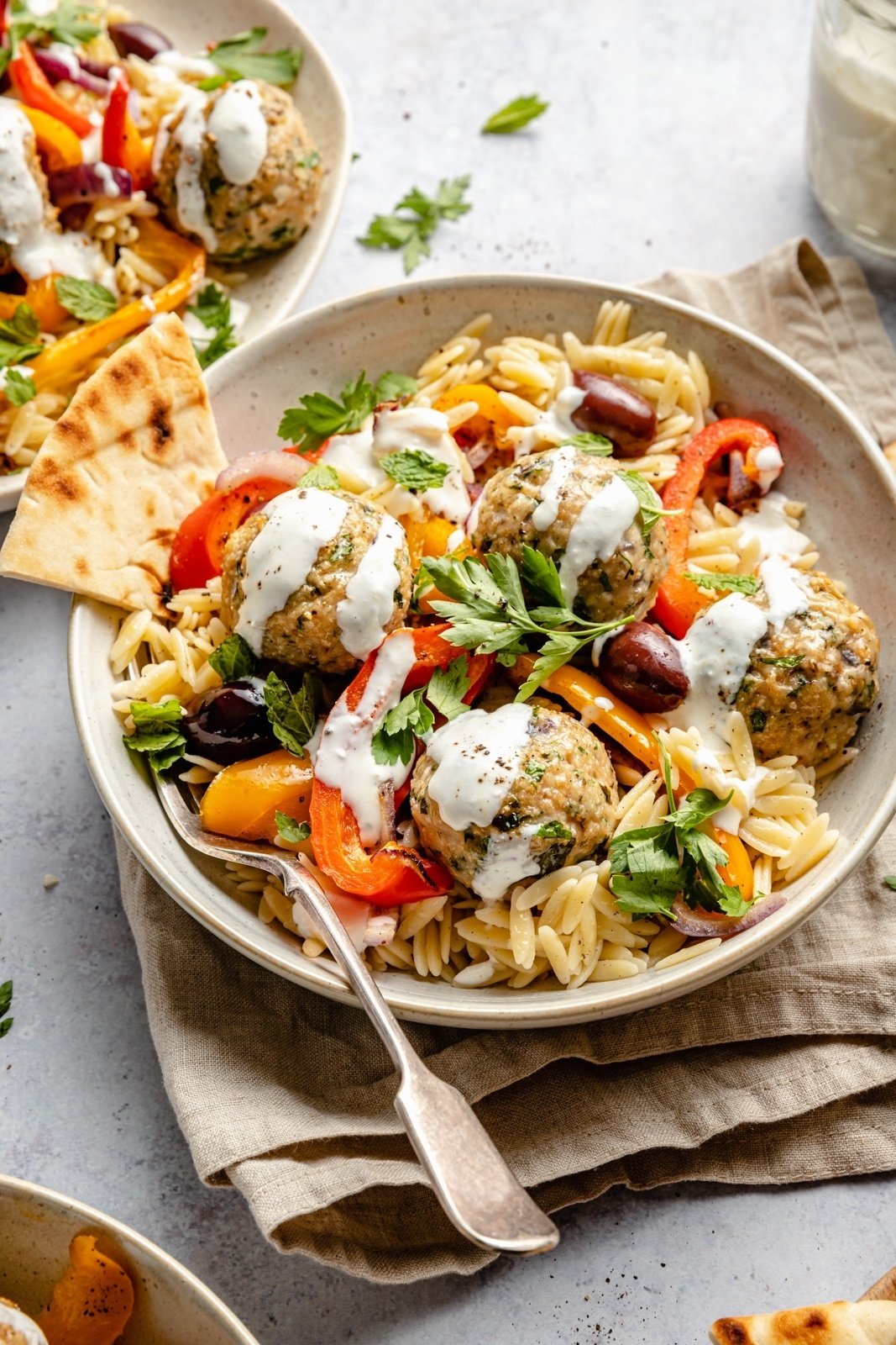 Greek turkey meatballs with orzo and veggies in a bowl