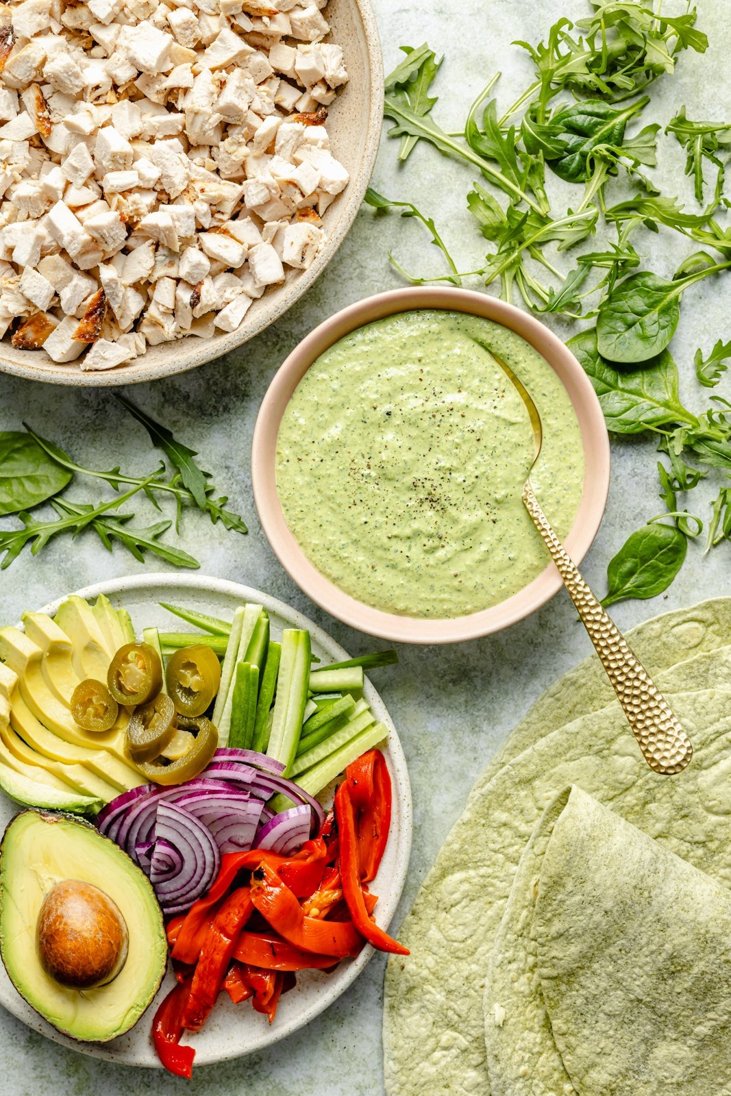 ingredients for high-protein green goddess chicken wraps in bowls