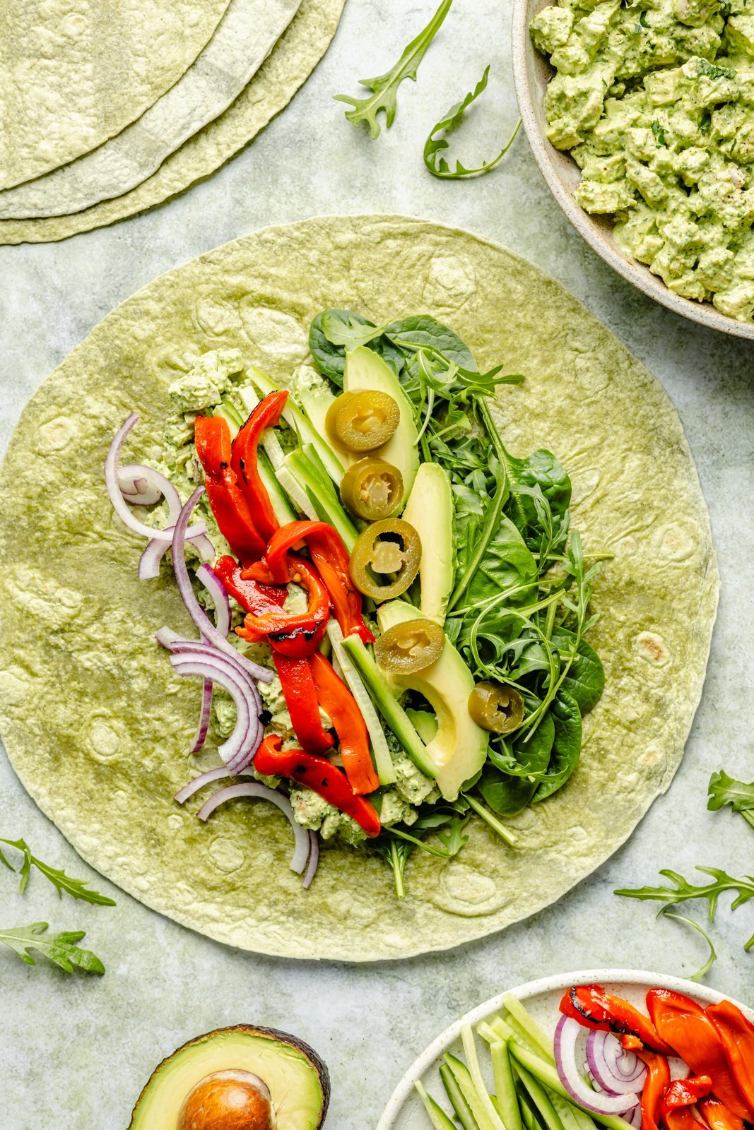 protein-packed green goddess chicken salad wrap opened on a board