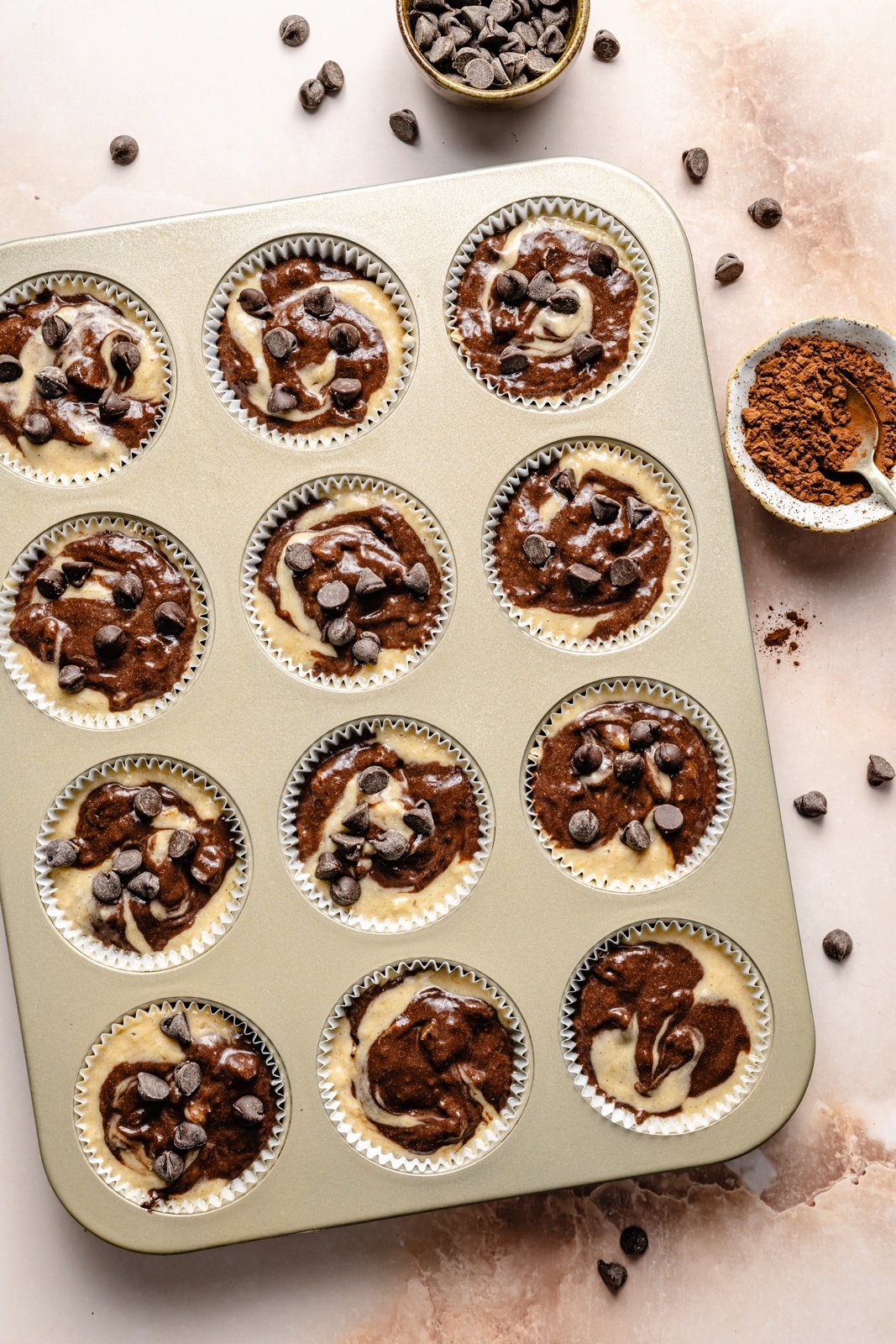 unbaked marbled banana muffins in a muffin tin