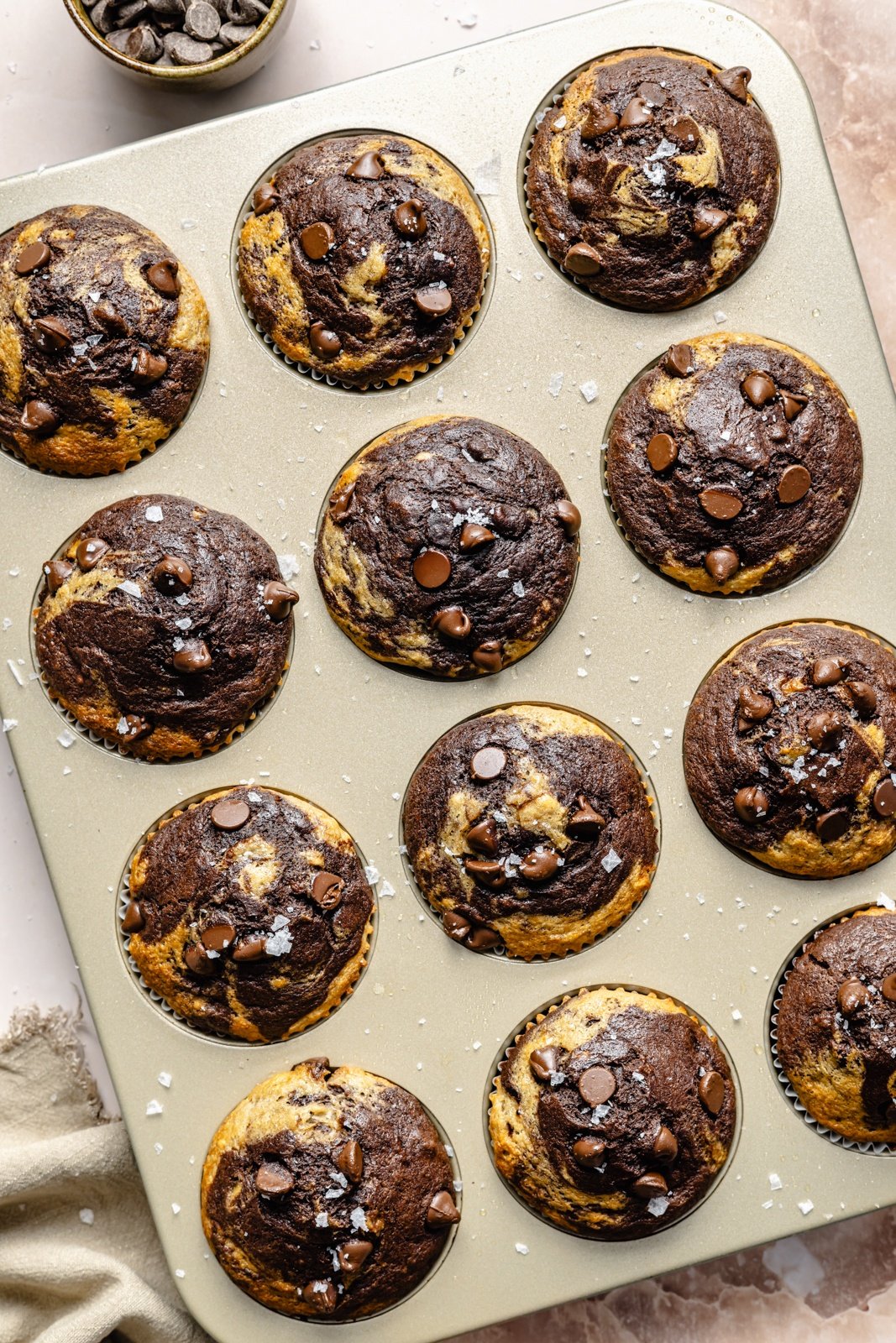marbled chocolate banana muffins in a muffin tin