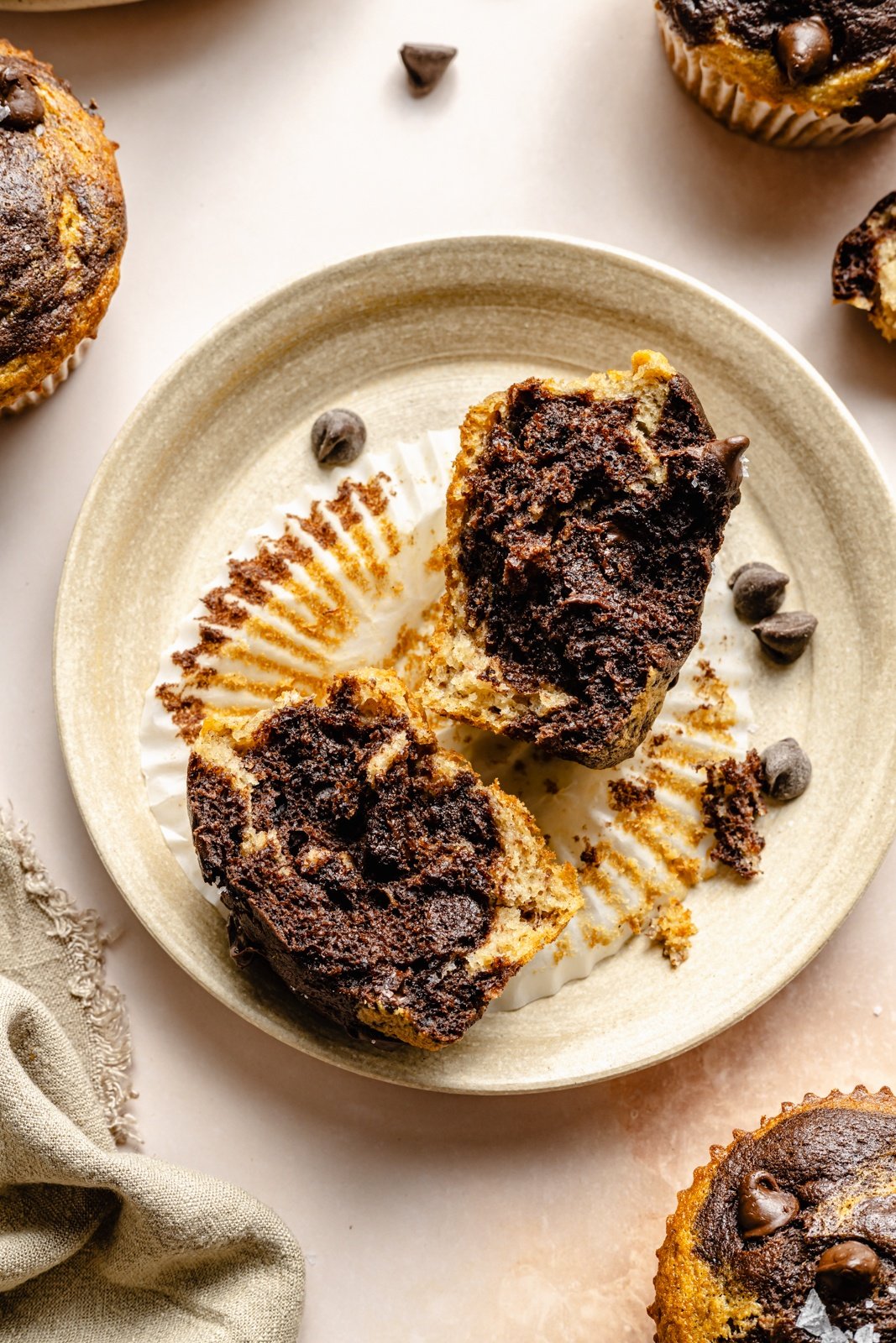 marbled banana muffin split in half on a plate
