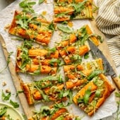roasted carrot tart sliced on a cutting board
